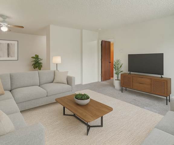 An empty carpeted bedroom with a window at Rancho Tudor Apartments. 