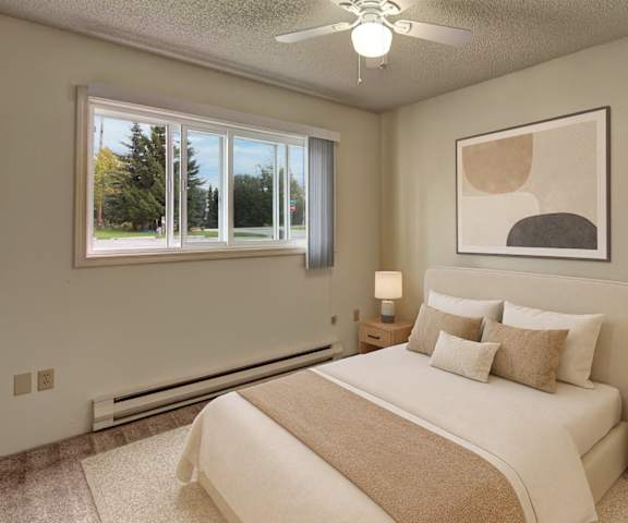 A large, empty living room with carpeting and a fireplace at Terrace on the Lake Apartment Homes. 