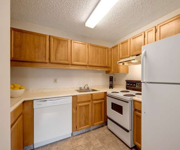An empty bedroom with a closet and a window at Gateway Square. 