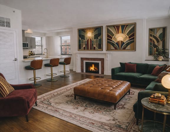 A living room with a fireplace and a red chair.