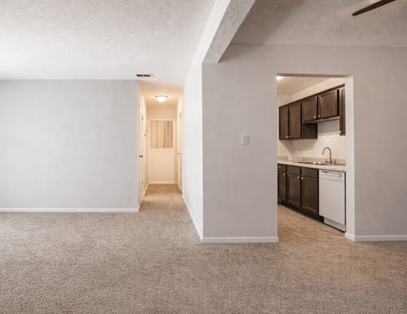 A bedroom with a bed, chair, and nightstand  at The Lodge Apartments, Indianapolis, IN, 46205.