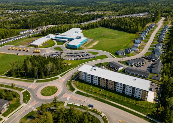 a view of the forest from the balcony of a modern building