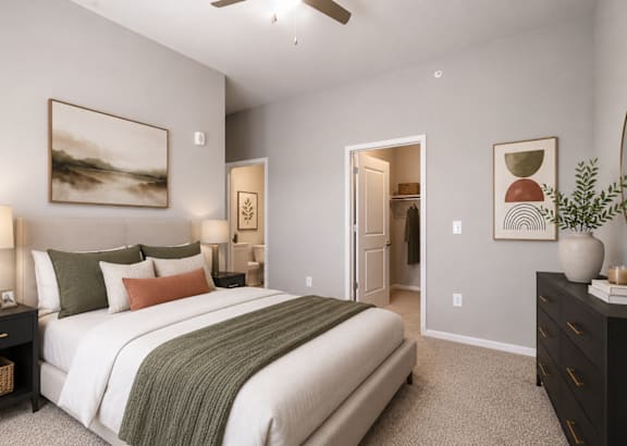 a bedroom with a bed and a wall of pictures on the wall above it at Residence at Riverwatch in Augusta, GA 30909