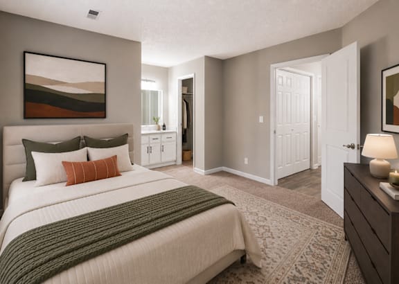 A bedroom with a bed, nightstand, and a lamp. at Woodwinds, Aiken, 29803