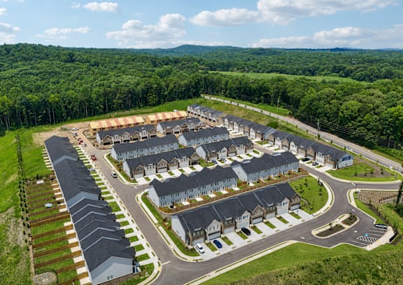 A bird's eye view of a residential area with houses and roads.