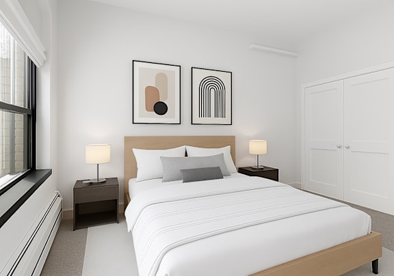 A bedroom with a large bed, two nightstands, and two framed artworks on the wall.