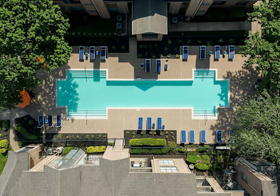 swimming pool in front of apartment buildings.at Villages of Briar Forest, Houston, TX