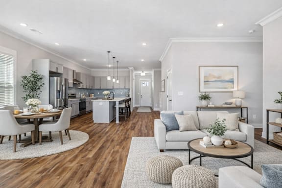 A modern living room with a dining table and chairs.