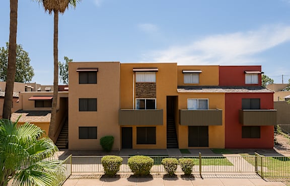 A modern building with a red, yellow and beige exterior.