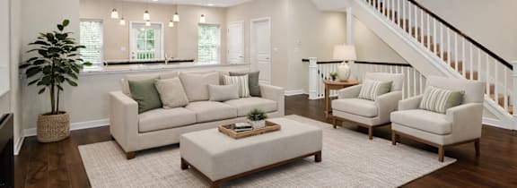 A living room with a staircase and a couch.