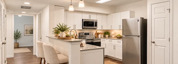 A modern kitchen with white cabinets and a central island.