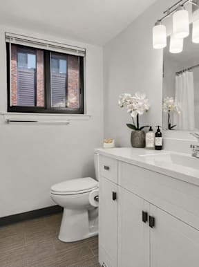 a bathroom with a white tub and shower at Lafayette Park Place, Detroit, 48207