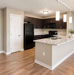 A room with wooden floors and white walls.at Hawthorne Pointe, Bondurant, IA