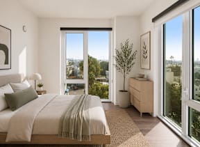 A studio bedroom with a large bed and a view of the city.