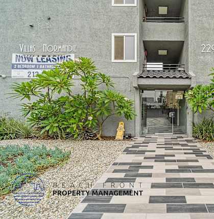 A building with a sign that says "Villas Normandie" and "Now Leasing" is shown.