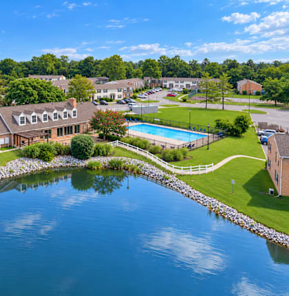 A house is surrounded by water and has a pool.