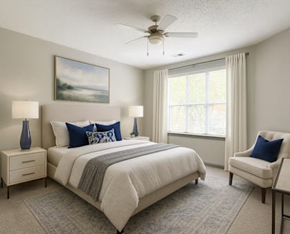 A bedroom with a large bed, a chair, and a painting on the wall.