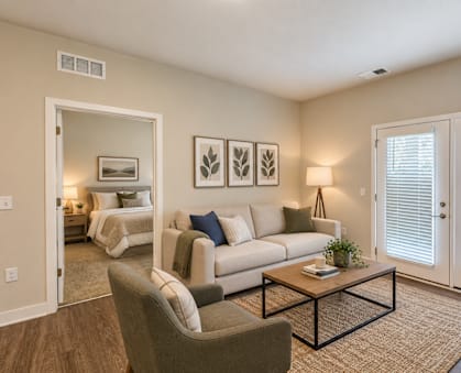 A living room with a couch, chair, and a coffee table.