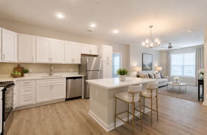 A modern kitchen with white cabinets and a large island.