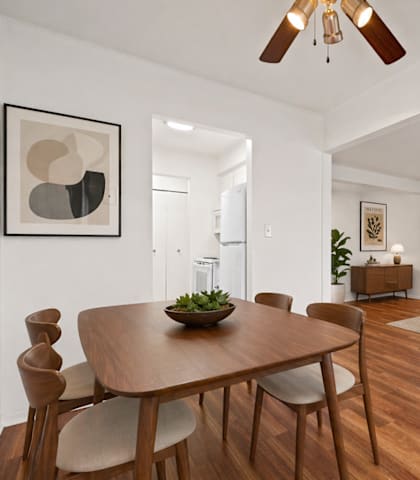 A modern dining room with a wooden table and chairs.