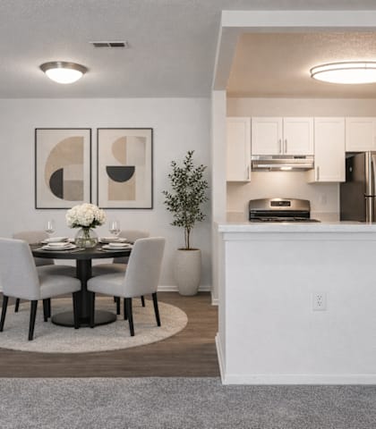 A modern dining room with a table set for two.