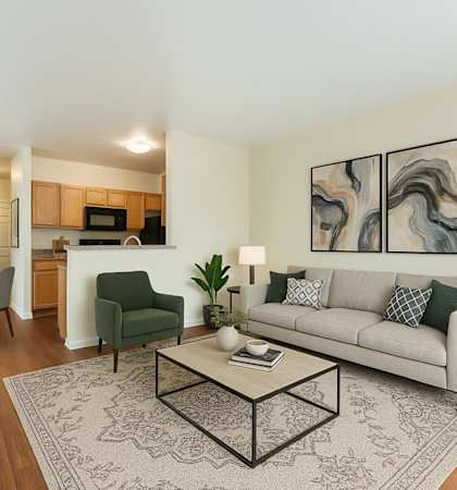 A living room with a couch, chairs, and a coffee table.