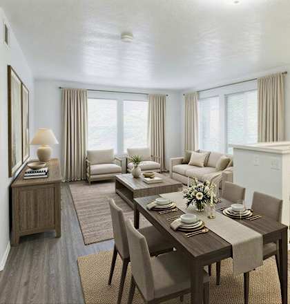 A living room with a couch, a coffee table, and a dining table.