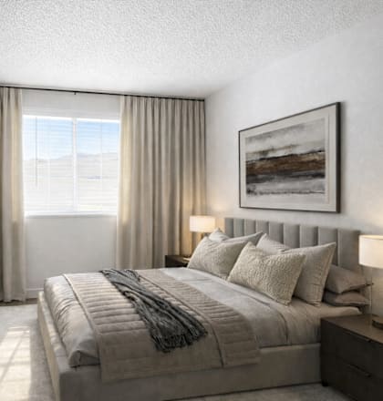 A bedroom with a large bed and a flat screen TV mounted on the wall.