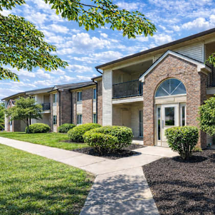 A sunny day at a residential complex with a clear blue sky.