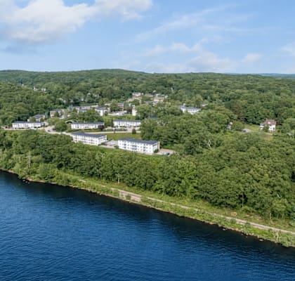 A bird's eye view of a resort by a lake.