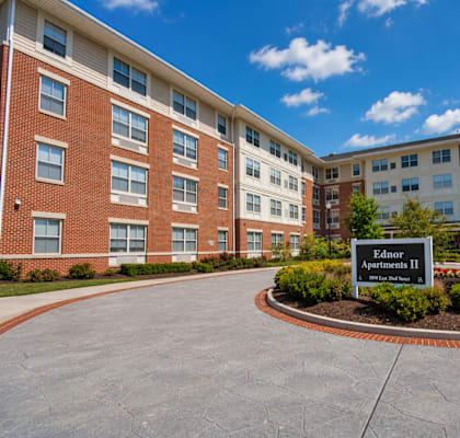 A sign in front of a building that says Ednor Apartments II.