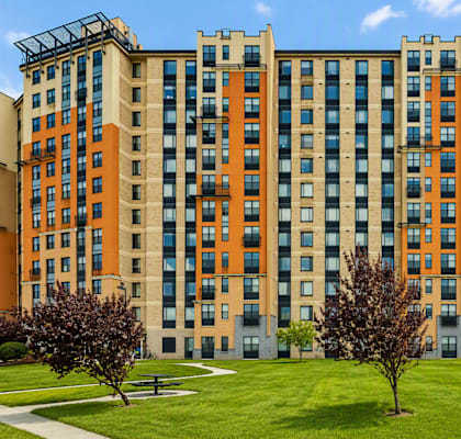 A large building with a green lawn in front.