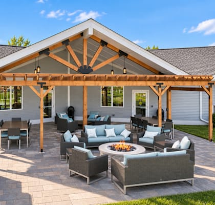 A patio with a fire pit and seating area.