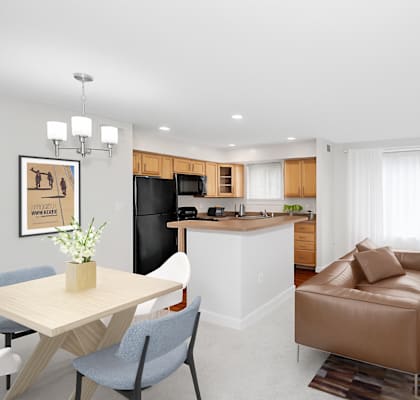 A modern living room with a brown leather sofa and a wooden dining table.