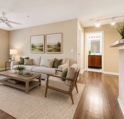 A living room with a couch, a coffee table, and a ceiling fan.