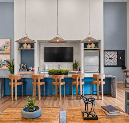 A modern kitchen and dining area with a blue accent wall.