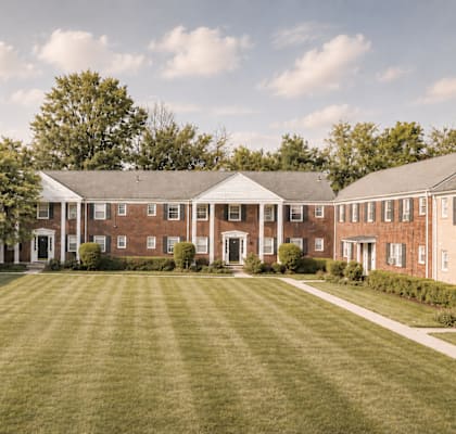 A large building with a lawn in front of it.