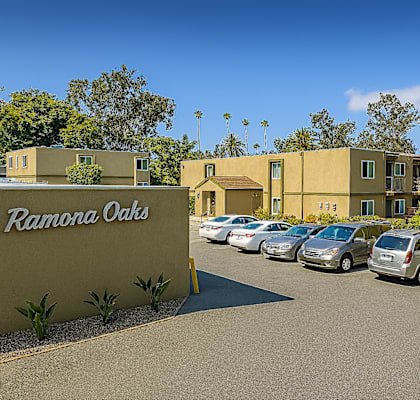 Ramona Oaks is a residential complex with multiple buildings and parked cars.