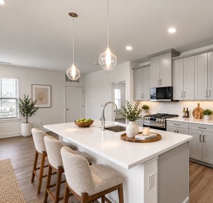 A modern kitchen with a white island and stainless steel appliances.
