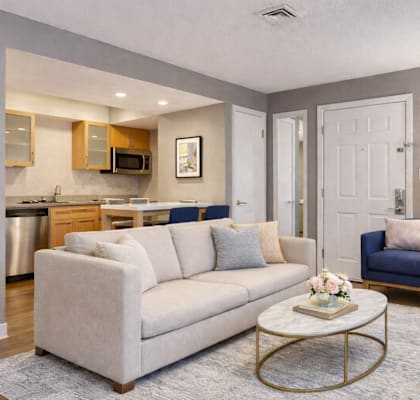 A living room with a white couch and a coffee table.