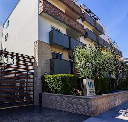 an apartment building with a wooden gate and a sign that reads 1238