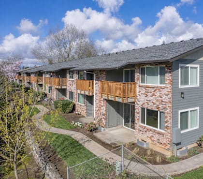 Apartment complex with a mix of brick and siding exteriors.