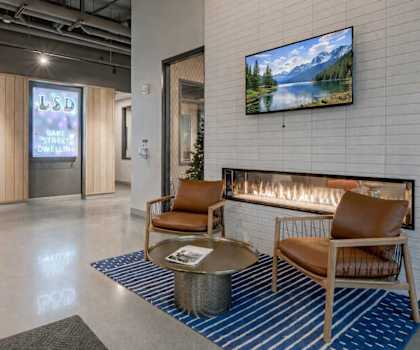 A modern waiting room with a flat screen TV mounted on the wall.