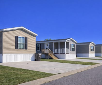 A line of houses with a clear blue sky above them.