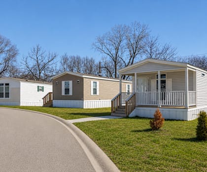 A row of houses with a driveway in front.