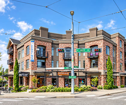 A street view of a building with a sign that says "ROY ST".