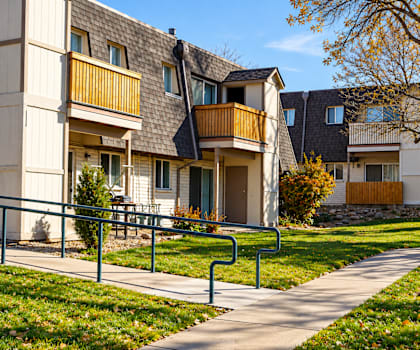 Apartment buildings with a walkway in front.