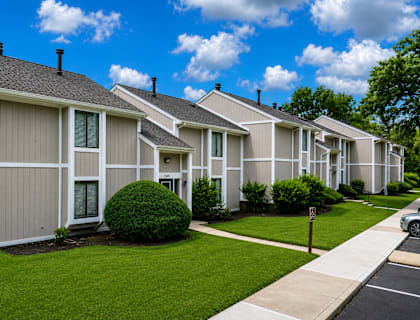 A row of houses with a car parked on the street.