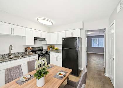 Updated kitchen in Marietta GA apartment with black appliances and granite-style counters