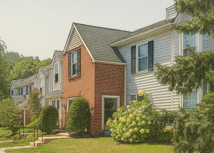 A house with a red brick facade and a grey roof.